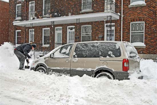 Shoveling a Minivan Out of the Snow Shoveling a Minivan Out of the Snow